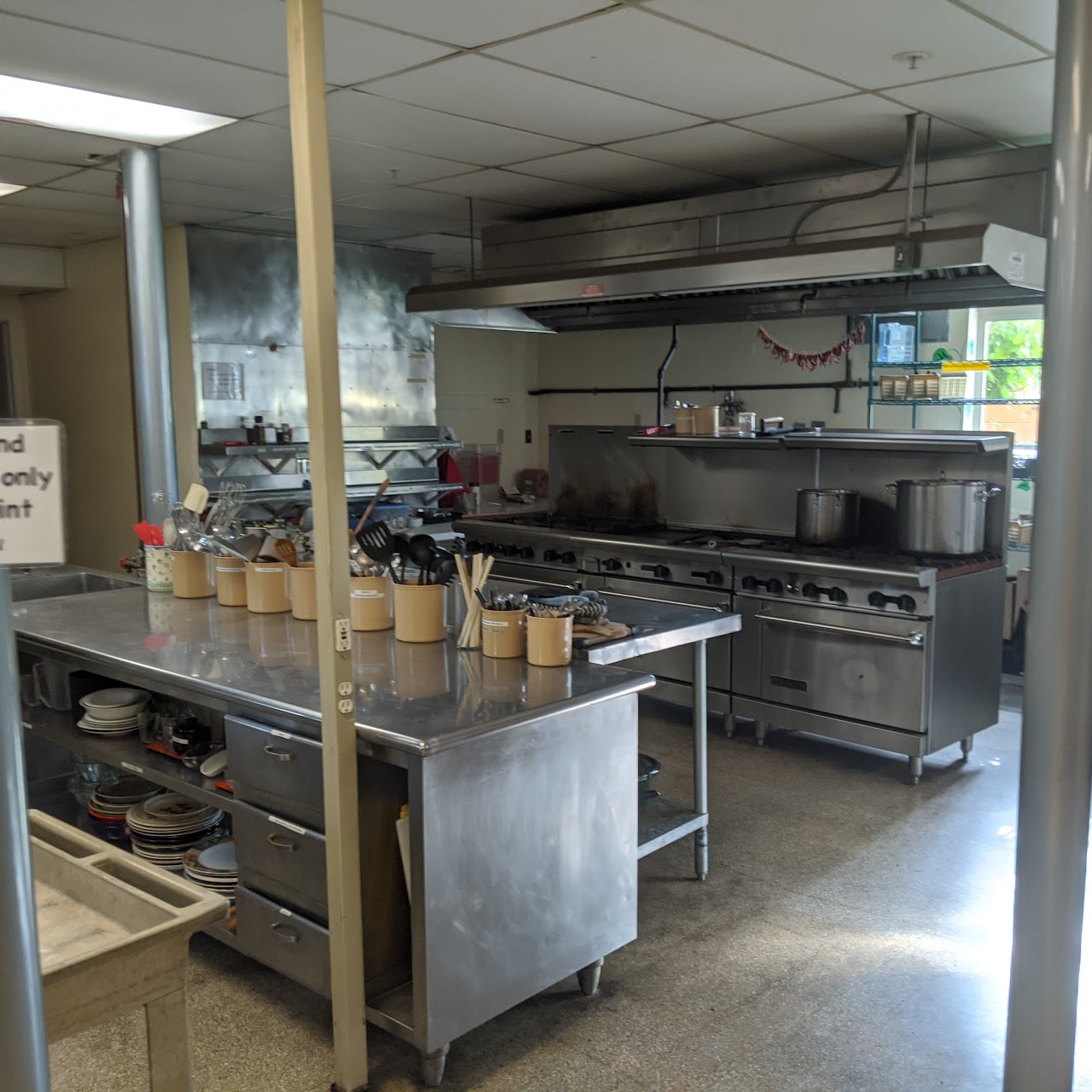 Earlier photograph of the commercial kitchen; not current condition